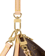 Louis Vuitton Multipass Monogram bag angled view with compact structured silhouette.