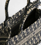 MOAH Christian Dior small book tote in navy and beige embroidered textile with iconic Oblique motif and top handles.