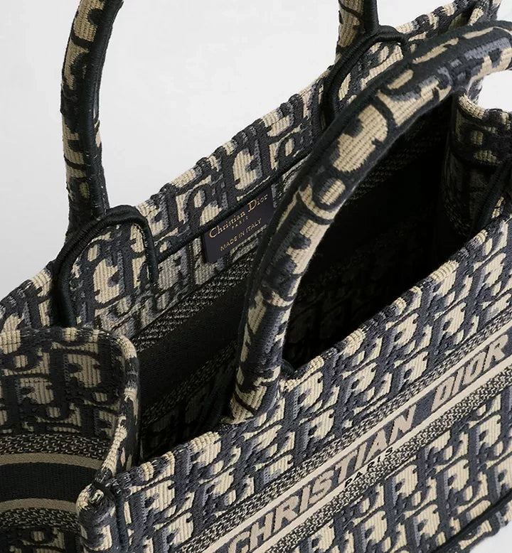 MOAH Christian Dior small book tote in navy and beige embroidered textile with iconic Oblique motif and top handles.