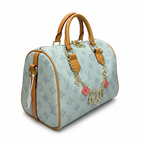 MOAH light blue monogram canvas barrel handbag with tan leather trim and decorative gold chain with floral charms