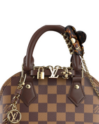 MOAH Louis Vuitton Alma Nano handbag in Damier Ebene canvas with brown leather trim and gold-tone hardware details.