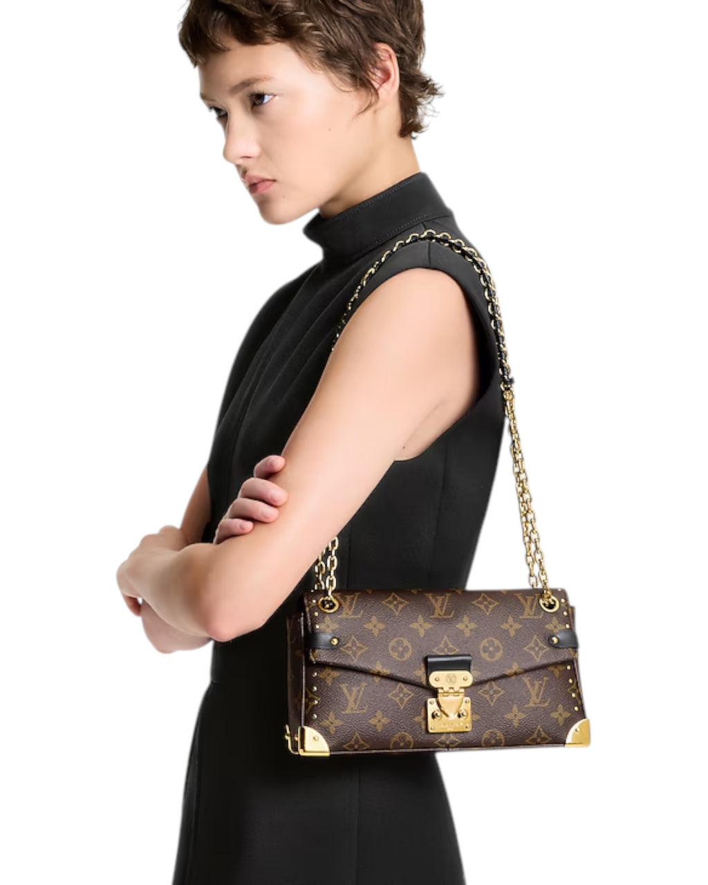 Model wearing the Louis Vuitton Trunkie monogram canvas shoulder bag with gold-toned rivets and S-lock clasp.