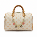MOAH monogram canvas barrel handbag with tan leather trim and gold-tone chain featuring pink floral charms