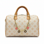 MOAH monogram canvas barrel handbag with tan leather trim and gold-tone chain featuring pink floral charms