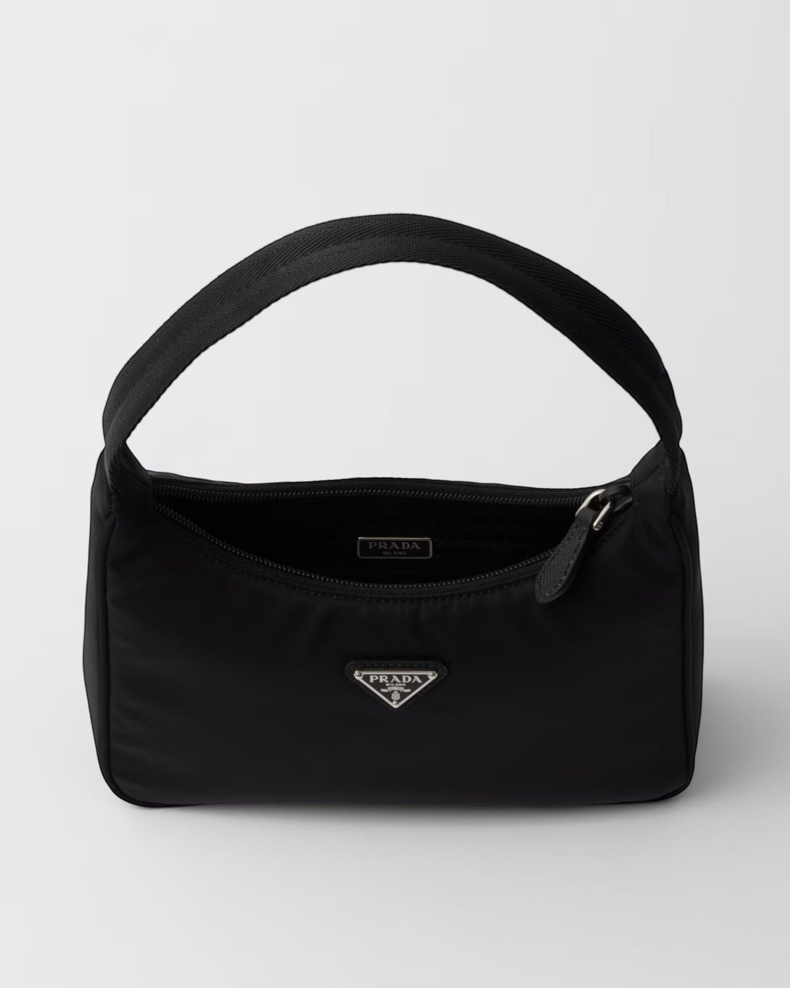 MOAH Prada Re-Edition 2000 mini bag in black recycled Re-Nylon with a woven handle and enameled metal triangle logo.