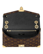 Louis Vuitton Trunkie monogram canvas shoulder bag interior view with gold hardware and chain strap.